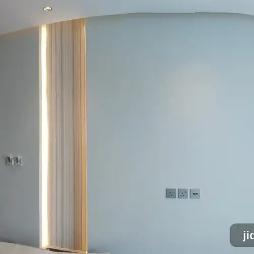 جدار أزرق فاتح مع أعمدة مضلعة وإضاءة LED مخفية في الرياض